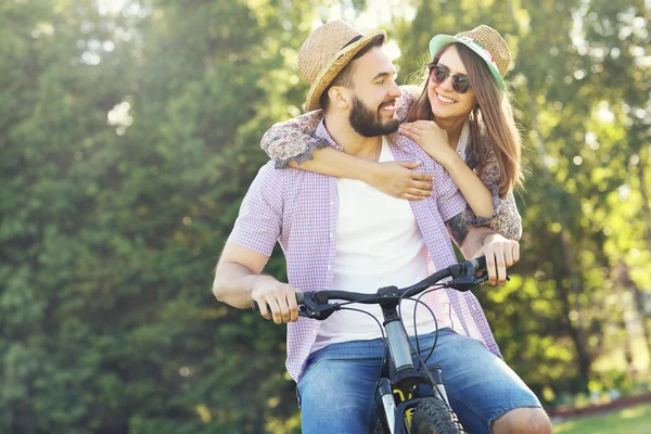 Romantic couple riding bike — Stock Photo, Image