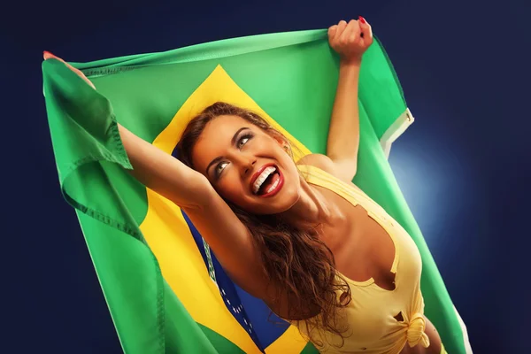 Happy Brazilian fan cheering with flag — Stock Photo, Image