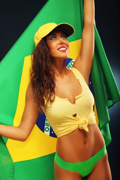 Happy Brazilian fan cheering with flag — Stock Photo, Image