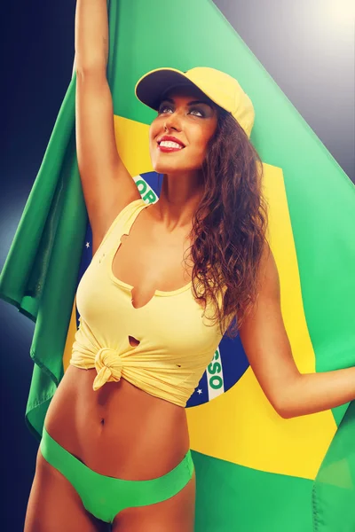 Happy Brazilian fan cheering with flag — Stock Photo, Image