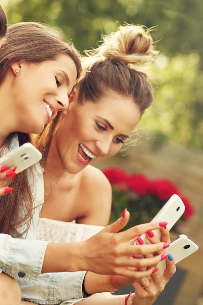 Šťastný skupina přátel s chytrými telefony — Stock fotografie