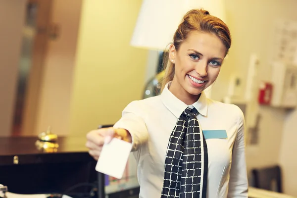 Ładny recepcjonista dając klucza cardreceptionist dając kartę-klucz — Zdjęcie stockowe