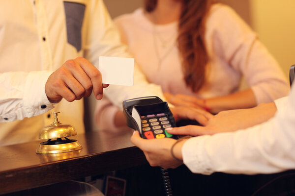 couple at counter paying for hotel