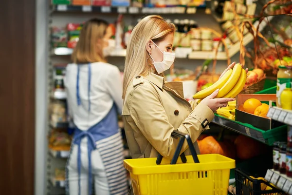 Доросла жінка в медичній масці покупки для продуктів харчування — стокове фото