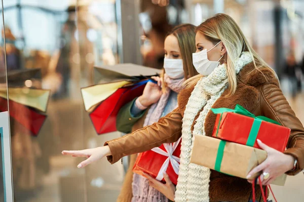 Retrato de dois amigos comprando juntos usando uma máscara, conceito coronavírus — Fotografia de Stock