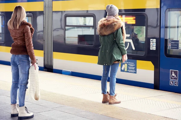 People keeping social distance at train station