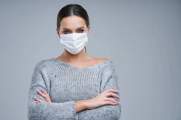 Portrait of beautiful woman in mask on gray background — Stock Photo, Image