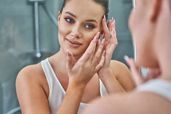 Vrouw op zoek naar reflectie in de spiegel na douche — Stockfoto