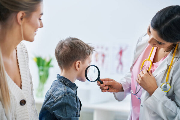 Little boy having medical examination by dermatologist