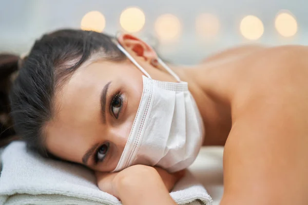 Dospělá žena v masce při relaxační masáži v lázních — Stock fotografie