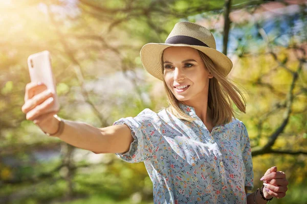 Vrouw met telefoon in het park. — Stockfoto