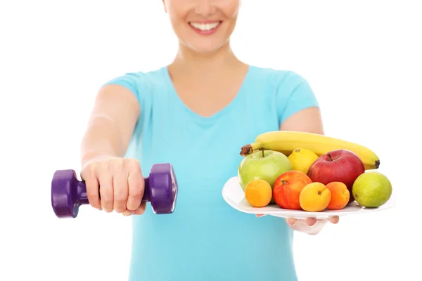 Woman with fruits and dumb-bells Royalty Free Stock Images