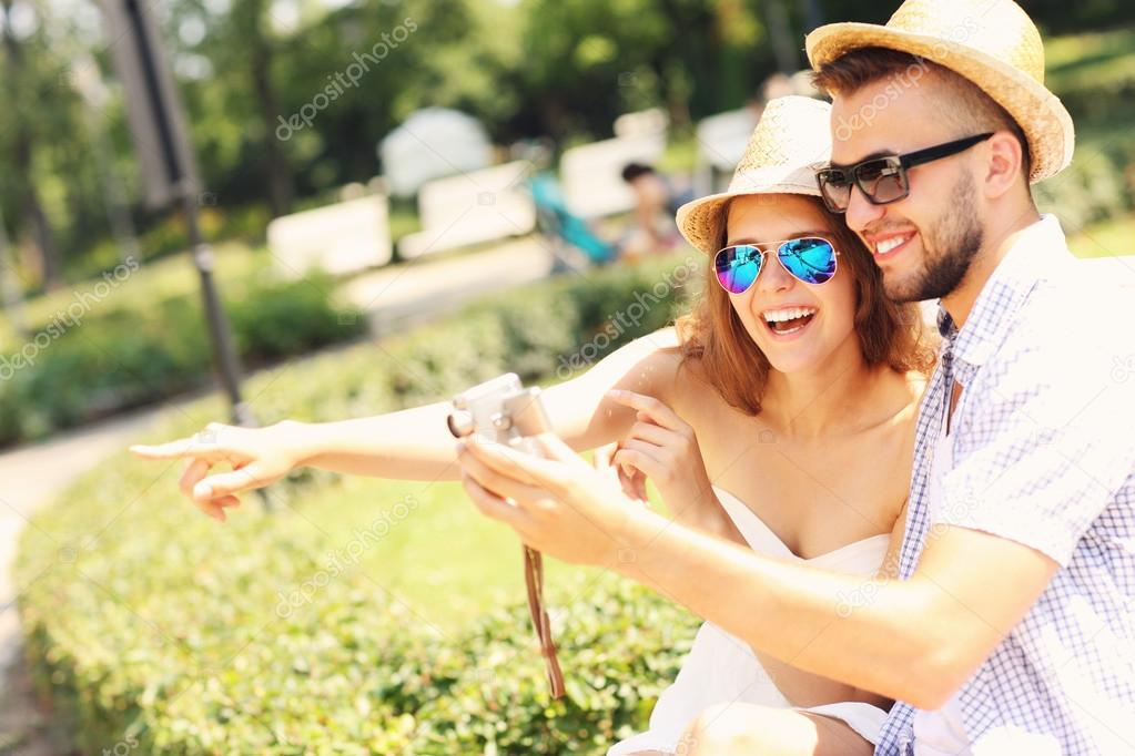 Couple of tourists taking pictures in the park