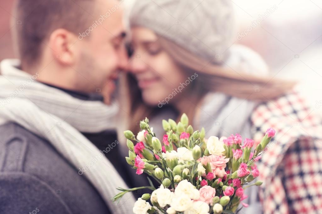 Flowers and kissing couple in the background