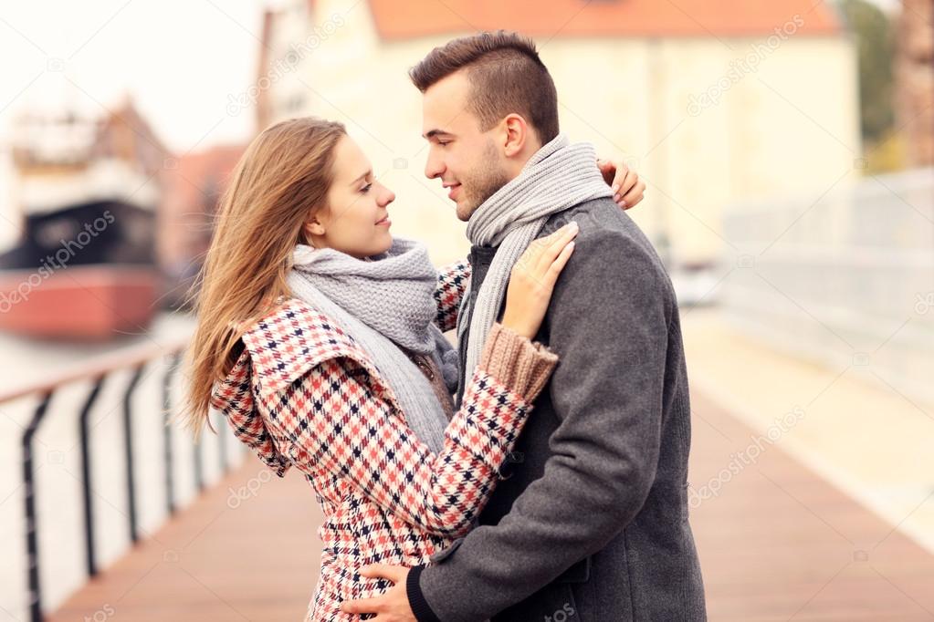 Beautiful couple hugging on a date in the city