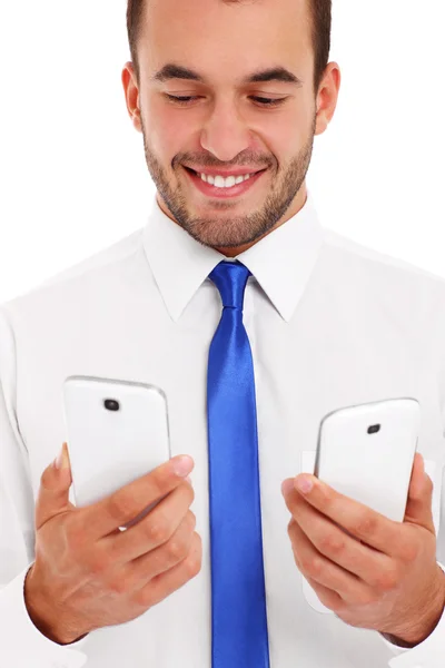 Бізнесмен з двома смартфонами — стокове фото