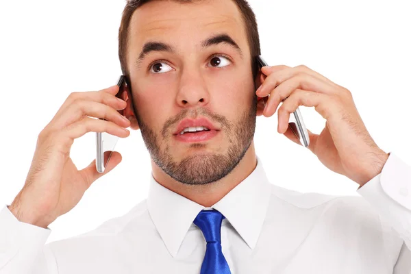 Empresário falando em dois telefones — Fotografia de Stock