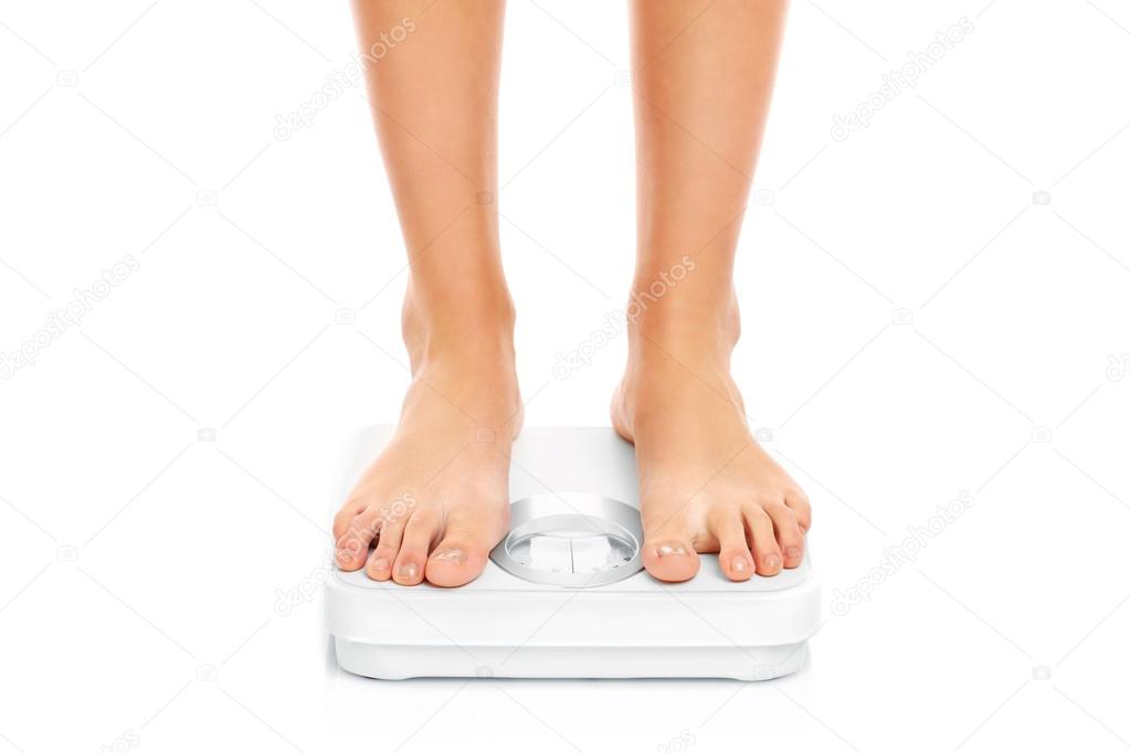 Woman feet on bathroom scales