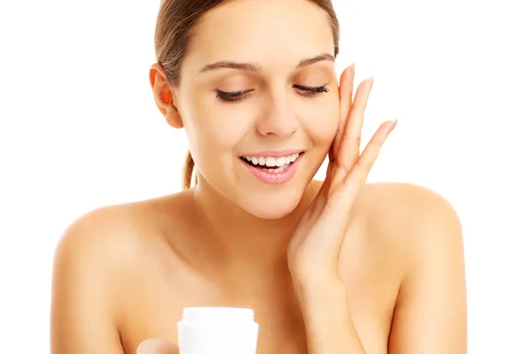 Pretty woman applying cream on face Royalty Free Stock Photos