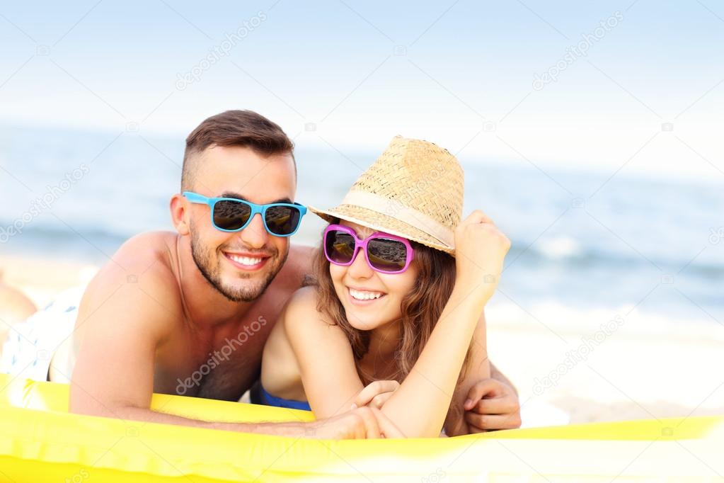 Young couple sunbathing on the beach