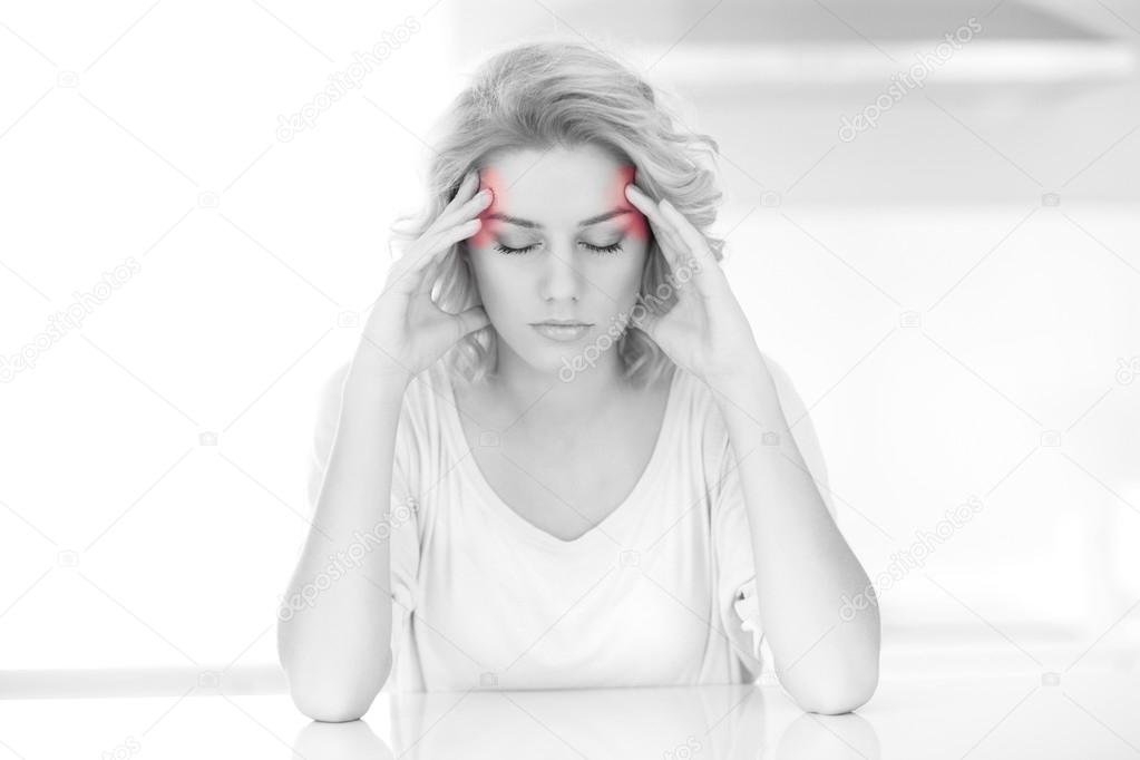 Adult woman having headache at home