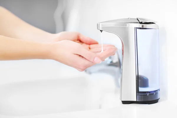 Hands and automatic soap dispenser — Stock Photo, Image