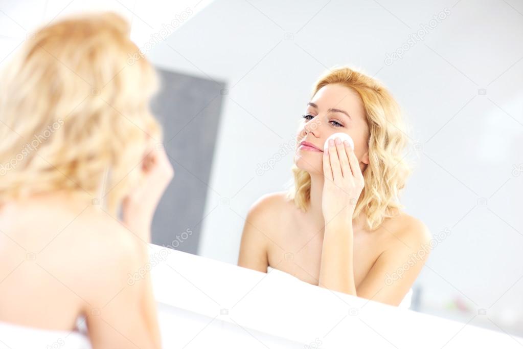 Woman cleaning face