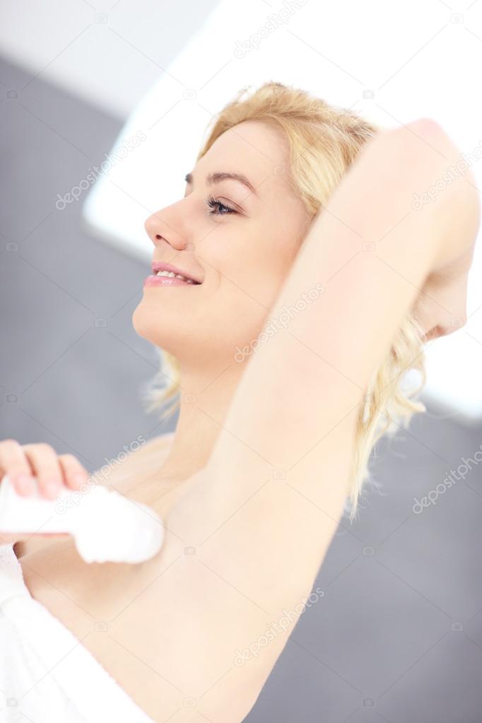Woman using deodorant
