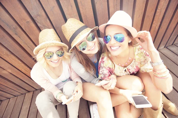 Amigos do sexo feminino usando smartphones — Fotografia de Stock