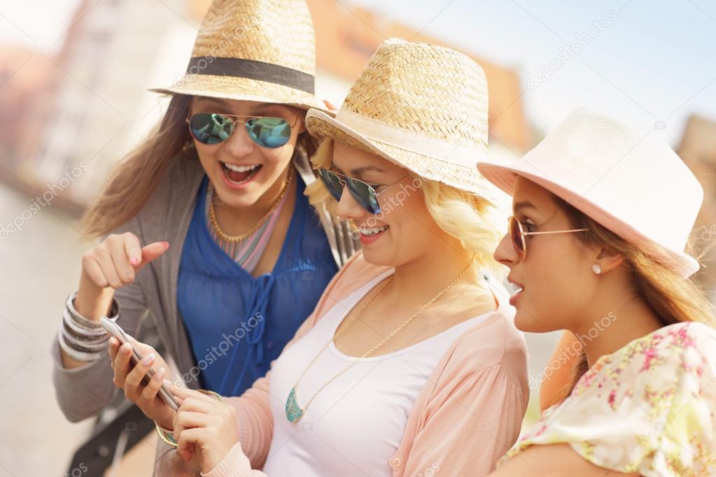 Three friends using smartphone