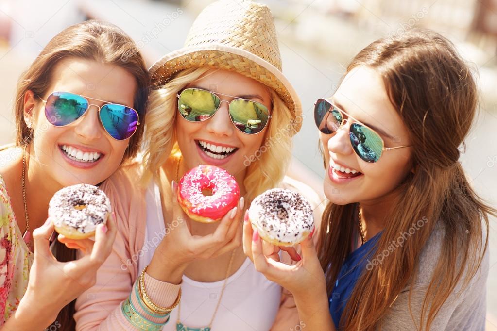 Group of friends eating donuts