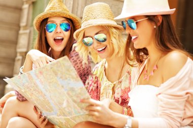 Group of tourists using map clipart
