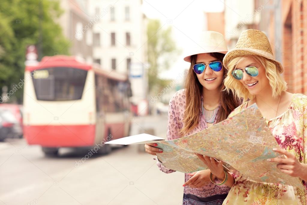 friends using map in the city
