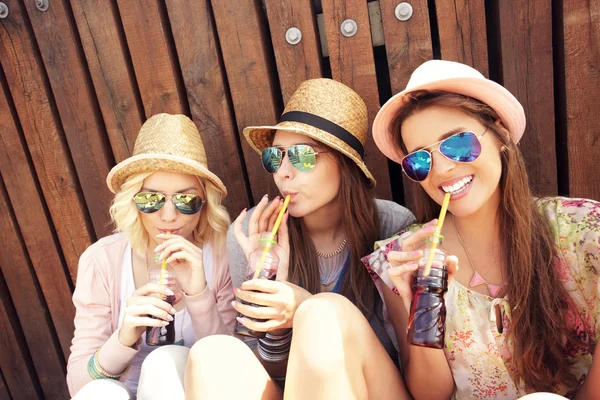 Meisje vrienden frisdrank drinken op de pier — Stockfoto