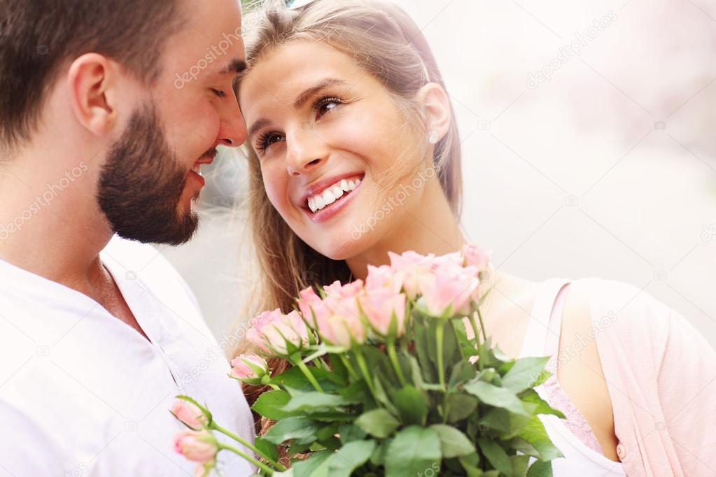 Young romantic couple with flowers