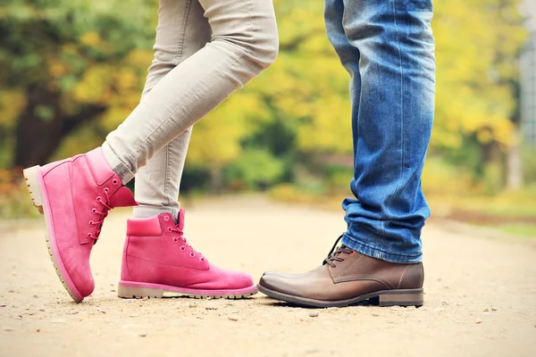 Couple's legs in the park in autumn — Stock Photo, Image