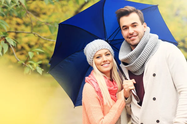 Young romantic couple with umbrella — Stock Photo, Image