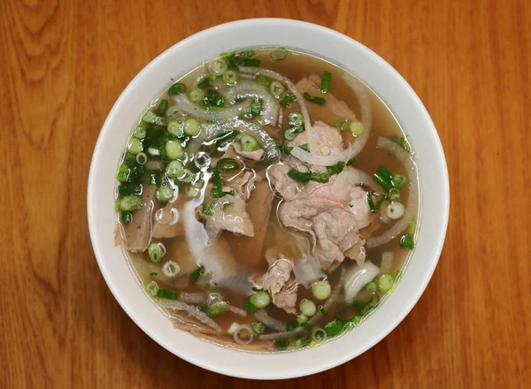 Vietnamese rice noodle soup with sliced rare beef.