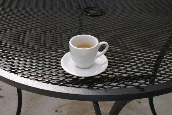 Ceramic cup of coffee on table in coffee shop cafe. Coffee cup latte art in cafe on wooden table. Classic Coffee Cup, Italian Cappuccino. Delicious Morning hot drink. Latte with Croissant. Breakfast drink.