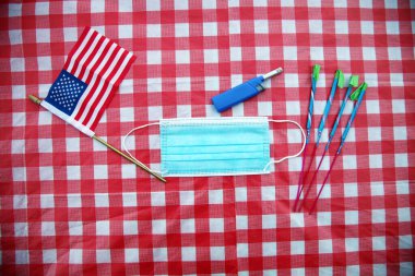 Amerikan Bağımsızlık Günü. 4 Temmuz kutlu olsun. ABD Bağımsızlık Günü. Amerikan bayrağı. 4 Temmuz. Bağımsızlık Günü. Masa örtüsü üzerindeki kağıt surat maskesi. Covid-19 4 Temmuz hazırlığı. Coronavirus Pandemik Hazırlık. Covid 19. 