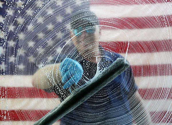 4th of July Window Washing. Window Cleaning. Window Washing. American flag background. Fourth Of July Patriotic Celebration. Cleaning windows for the Fourth of July Celebration.