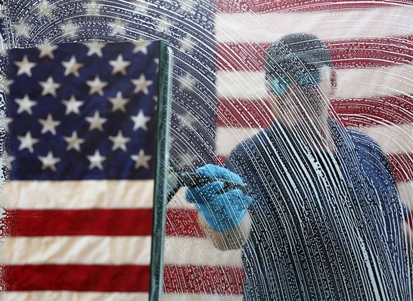 4th of July Window Washing. Window Cleaning. Window Washing. American flag background. Fourth Of July Patriotic Celebration. Cleaning windows for the Fourth of July Celebration.