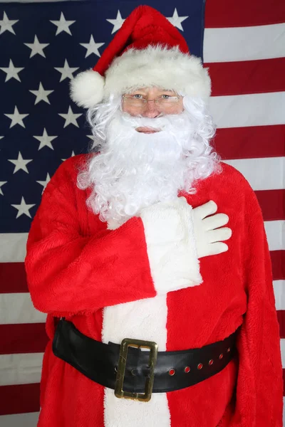 American Independence Day. Happy 4th of July. USA Independence Day. American flag. Santa Claus with American Flag. Santa in front of the American Flag Smiles and Points. Santa Claus says Happy 4th of July and Merry Christmas to all. Happy Holidays.