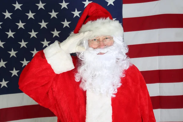 American Independence Day. Happy 4th of July. USA Independence Day. American flag. Santa Claus with American Flag. Santa in front of the American Flag Smiles and Points. Santa Claus says Happy 4th of July and Merry Christmas to all. Happy Holidays.