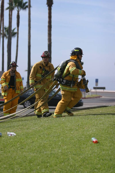 LAGUNA BEACH, CA - FEB 19: Firefighter recruit sprays water during fire fighting drills at the local Fire Department training area on February 19, 2009 in Laguna Beach, California. Fire Fighters training to use fire equiptment. 