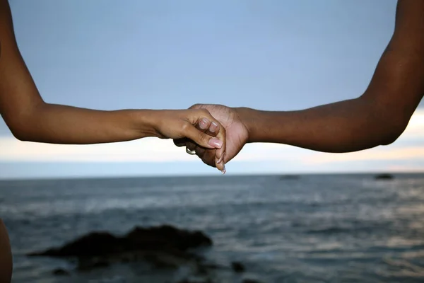 Lovers couple holding hands. couple holds hands. African american couple holding hands. standing on the beach. travel. vacation. retirement. lifestyle concept. Love. Romance. Love, Affection And Bonding Concept. holding hands. Romantic Relationship