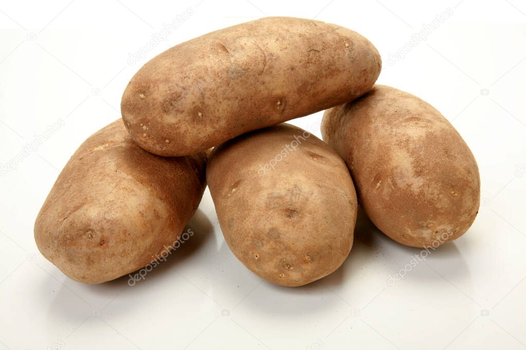 Potato. Russet Potato. whole raw potatoes. purple potatoes. sweet potatoes. organic yellow raw potato. vegetable. carbohydrate and starch. yellow potato. Purple sweet potato. Homegrown organic raw purple potato.