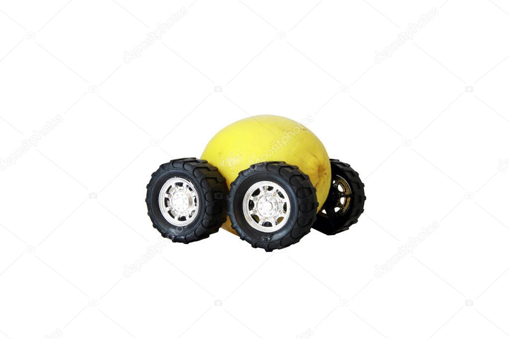 A lemon with wheels. defective vehicle. A lemon on wheels. driving a lemon. truck wheels on a yellow lemon. this car is a Lemon. isolated on white. room for your text.
