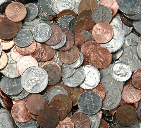 loose change. a pile of american coins. money from a piggy bank. savings bank. spare change. tip jar money. boob job money. savings account. allowance. Pile of vintage American coins with pennies, half dollars and nickels. shortage of loose change.