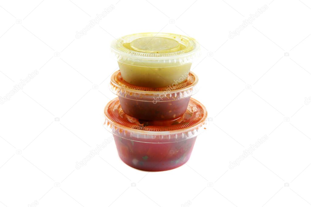 salsa. three hot salsa's in plastic containers. isolated on white. room for text. clipping path. Mango with Peach Salsa. hot sauce. Tomato salsa. salsa Roja. traditional Mexican sauce.  homemade recipe Pico de Gallo with nachos.
